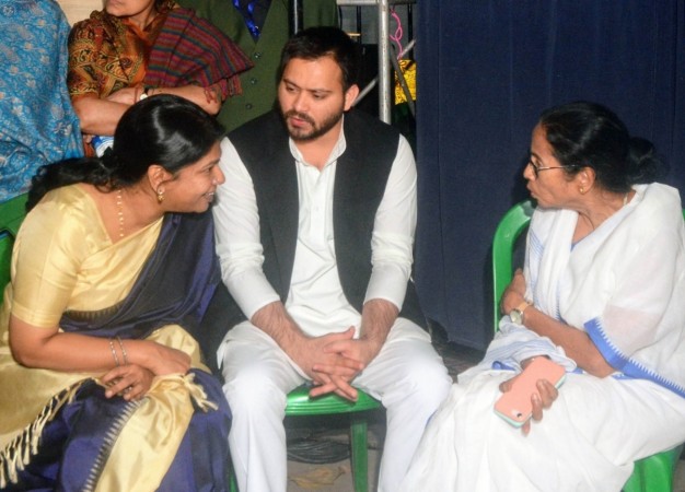 RJD leader Tejashwi Yadav and DMK Rajya Sabha MP Kanimozhi meets West Bengal Chief Minister Mamata Banerjee during a sit-in (dharna) demonstration over the CBI's attempt to question Kolkata Police Commissioner Rajeev Kumar in connection with a Ponzi scheme scam, near the Metro Channel in Kolkata on Feb 4, 2019. Mamata Banerjee Kolkata protest