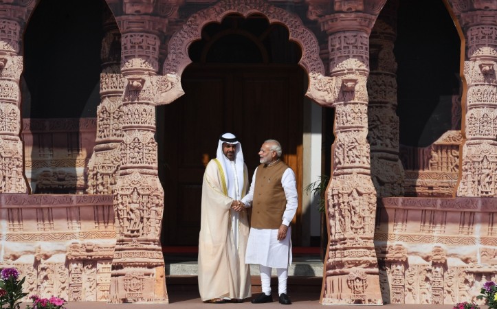 Indian Prime Minister Narendra Modi (R) welcomes Sheikh Hamed Bin Zayed Al Nahyan, Chairman of the Crown Prince Court of Abu Dhabi, to the founding conference of the International Solar Alliance in New Delhi on March 11, 2018. The International Solar Alliance (ISA) organizes more than 121 'sunshine' countries that are situated or have territory between the Tropic of Cancer and the Tropic of Capricorn, with the aim of boosting solar energy output in an effort to reduce global dependence on fossil fuels. abu dhabi crown prince Narendra modi