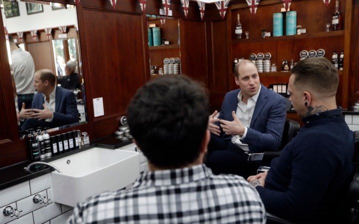Prince William, Duke of Cambridge speaks to Dean Hamilton, (R), and Paul Richardson, (L) as he visit to Pall Mall Barbers on February 14, 2018 in London, England. The Duke of Cambridge visited Pall Mall Barbers, Paddington Central, who are members of the Lions Barber Collective. The collective is an international group of top barbers who have come together to raise awareness for the prevention of suicide and provide training for barbers, called BarbersTalk. Prince William