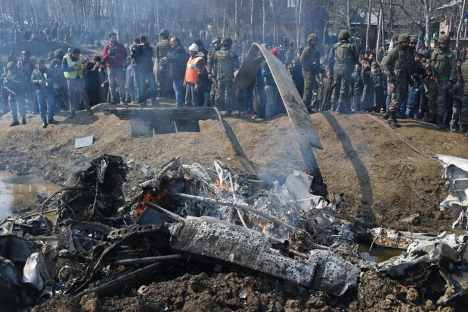 Indian soldiers and Kashmiri onlookers stand near the remains of an Indian Air Force aircraft after it crashed in Budgam district, on the outskirts of Srinagar on February 27, 2019. INDIA-PAKISTAN-KASHMIR-CONFLICT-MILITARY