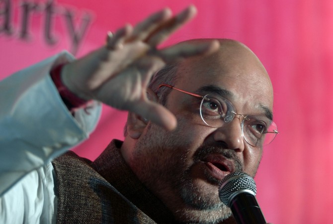 President of India's Bharatiya Janata Party (BJP) Amit Shah gestures as he addresses business leaders at a meeting organised by The Indian Chamber of Commerce (ICC) in Kolkata on August 12, 2015, during an interactive session entitled 'Economic agenda for the development of the Eastern Region'. President of India's Bharatiya Janata Party (BJP) Amit Shah
