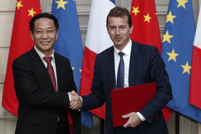 President of Airbus's commercial aircraft business Guillaume Faury (R) and Chairman of China Aviation Supplies Co. (CASC) Jia Baojun shake hands during an agreement signing ceremony at the Elysee Palace in Paris, on March 25, 2019, as part of a state visit. China airbus france