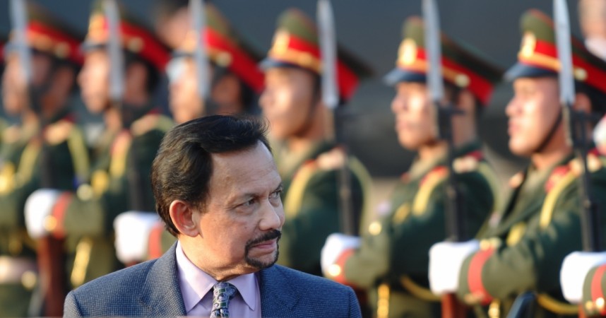 Brunei's Sultan Hassanal Bolkiah walks past an honour guard Brunei's Sultan Hassanal Bolkiah