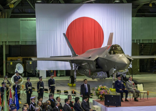 Senior leaders of Japan's Ministry of Defense, US Forces Japan, Pacific Air Forces and Lockheed Martin gather in a Japan Air Self-Defense Force hangar for the commemorative ceremony welcoming the first operational F-35A Lightning II to JASDF's 3rd Air Wing at Misawa Air Base, Japan on February 24, 2018. Japan F-35