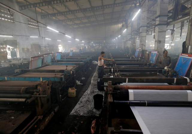 Employees work inside a sari, traditional clothing worn by women, manufacturing factory in Surat, India, March 8, 2019. indian factories