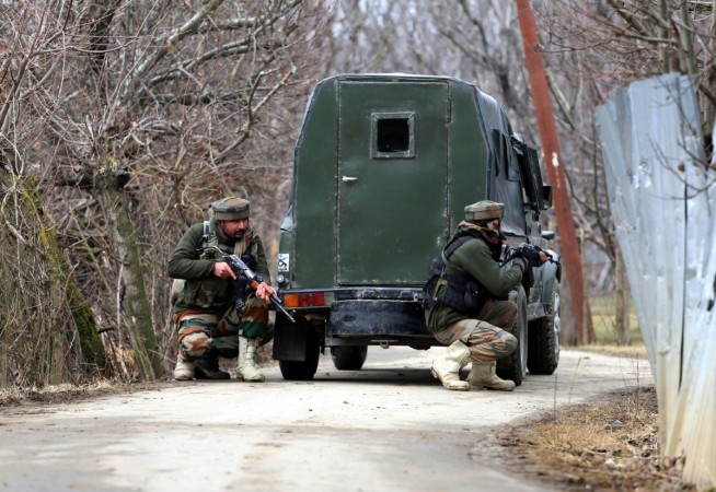 Soldiers take position during a gun-battle with militants at Rehmatabad village in Jammu and Kashmir's Sopore district on Feb 21, 2015. Two foreign guerrillas belonging to the Lashkar-e-Taiba (LeT) group were killed in the encounter. Soldiers take position during a gun-battle with militants at Rehmatabad village in Jammu and Kashmir's Sopore district on Feb 21, 2015.