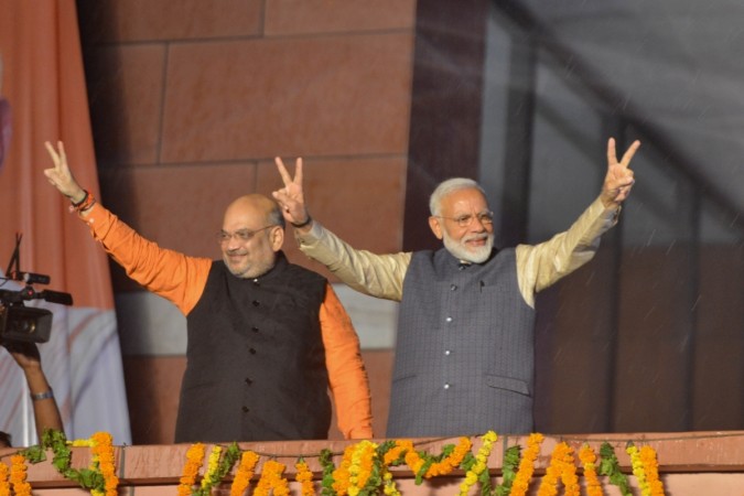 Prime Minister Narendra Modi and BJP chief Amit Shah wave at party workers during a party programme in New Delhi on May 23, 2019. Prime Minister Narendra Modi and BJP chief Amit Shah
