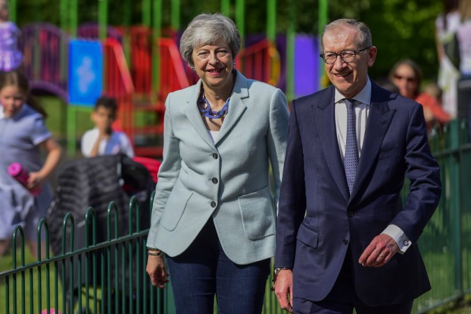 British Prime Minister Theresa May (L) arrives to vote at a polling station in Sonning, Britain, on May 23, 2019. Voters across Britain cast their ballots on Thursday for the European Parliament elections as it is widely forecast that Brexit Party will take a lead. Theresa May