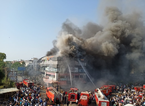 Students can be seen coming out of the windows of a coaching class in Surat and jumping off from the third and fourth floors . Surat fire