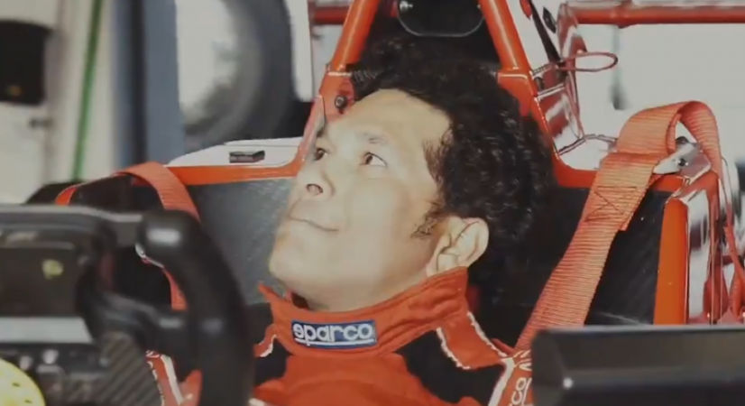 Sachin, seated in an F1 car, receiving instructions Sachin drives Formula 1 car