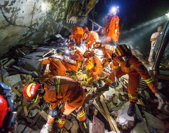 Rescuers try to save people buried under the rubble at Shuanghe township in China on June 18, 2019. China earthquake