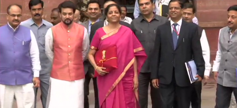 Finance Minister Nirmala Sitharaman posing outside the ministry with other officials. Nirmala Sitharaman