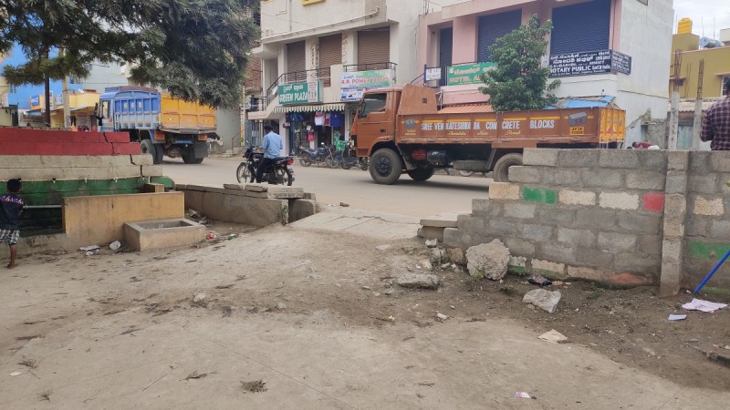 The half-built compound wall of government higher primary school in Medahalli with partially covered drainage. government higher primary school in Medahalli