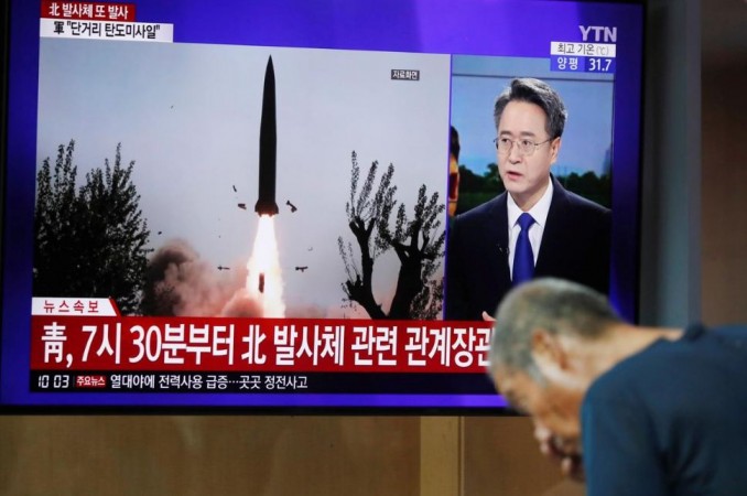 A man watches a TV showing a file picture for a news report on North Korea firing two unidentified projectiles in Seoul, South Korea, August 6, 2019. north korea missile launch