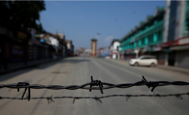 Barbed wire is seen laid on a deserted road during restrictions in Srinagar on August 5, 2019. article 370 kashmir
