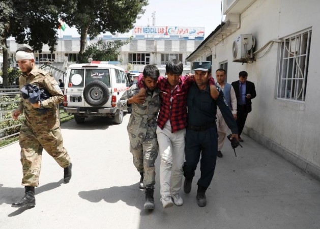 Officials carry an injured man to a hospital after the blast in Kabul, Afghanistan, August 7, 2019. kabul bombing