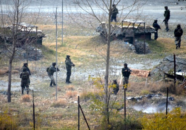 Soldiers take position during an encounter with heavily-armed militants at Mohra near the border town of Uri in Baramulla district of Jammu and Kashmir on December 5, 2014. Indian Army is in the midst of restructuring to provide more teeth to the Cold Start doctrine that will give the forces the capability for rapid deployment and deep strikes in enemy territory. Baramulla