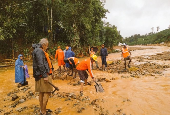 Personnel of the National Disaster Response Force (NDRF) and local people help with rescue operations in hill areas hit by landslides in Kerala. Kerala floods
