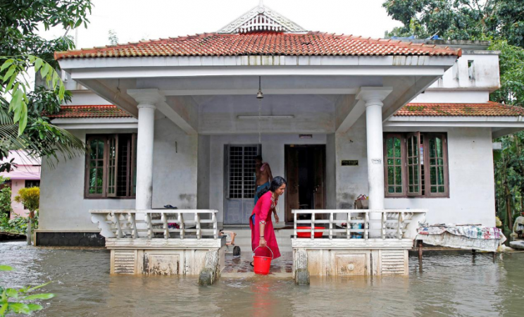 A woman clears out the water from her flooded house at Paravur on the outskirts of Kochi, in Kerala, India August 11, 2019. kerala floods