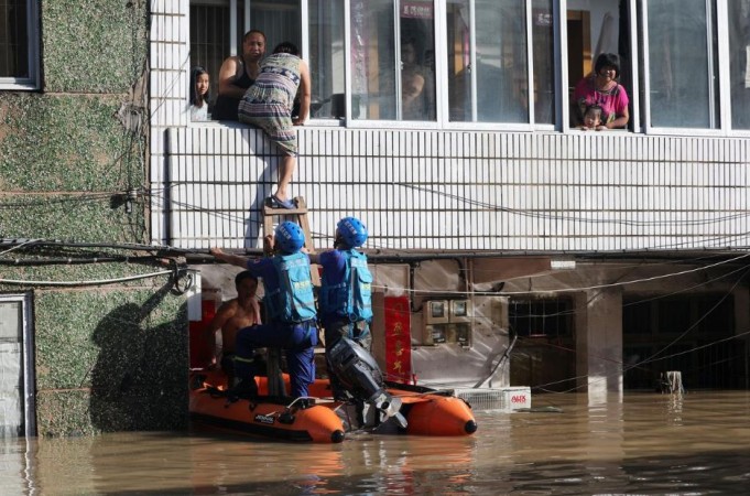 Rescue workers help residents stranded in a building in Taizhou, Zhejiang province, China August 11, 2019. Typhoon Lekima