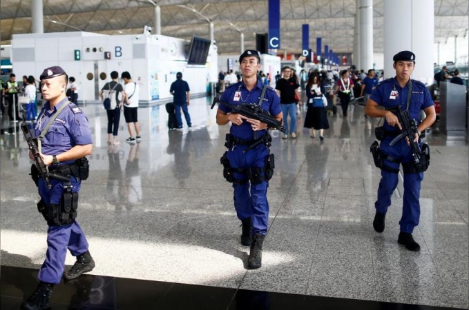 Armed police patrol the Hong Kong airport on Wednesday, August 14, 2019. Hong Kong airport protests