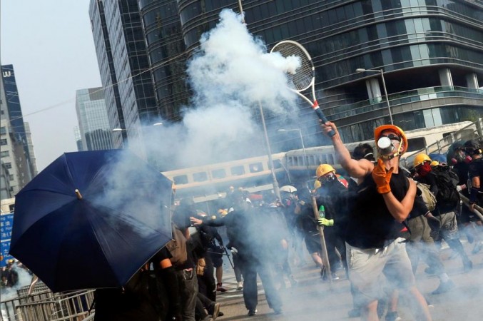 A demonstrator throws back a tear gas canister during a protest in Hong Kong, China, August 24 2019. Hong kong protests