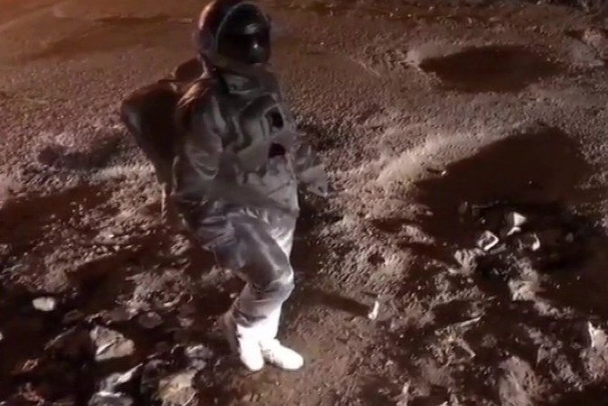 Baadal Nanjundaswamy, an artist dressed up as an astronaut in a Bengaluru road to highlight the pothole issues in the city Baadal Nanjundaswamy