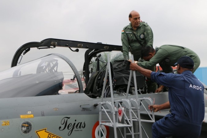 Defence Minister Rajnath Singh getting seated in the Indian Air Force Light Combat Aircraft Tejas before the historic sorties at the HAL Airport in Bengaluru that made him the first defence minister to fly on the supersonic indigenous fighter jet. He will repeat fly on a Rafale fighter jet on October 8 in France while receiving the first of the 36 aircraft. Defence Minister Rajnath Singh on Tejas LCA