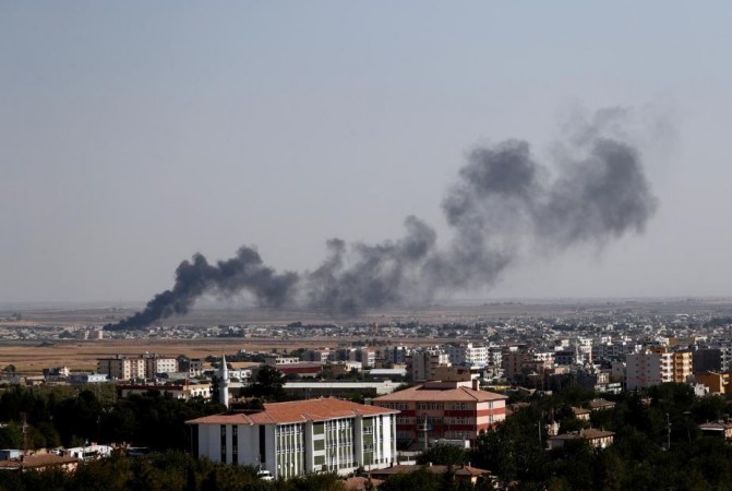 Smoke billows out after Turkish shelling on the Syrian town of Ras al Ain, as seen from the Turkish border town of Ceylanpinar, in Sanliurfa province, Turkey, October 13, 2019. US withdraw troops from Syria