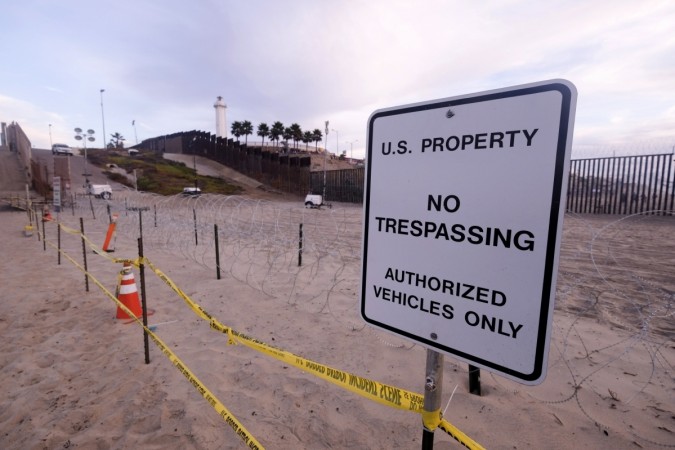 A sign and yellow tapes set by U.S. Border Patrol agents are seen in front of the border fence that divides the U.S. and Mexico in San Diego, California, the United States, Nov. 17, 2018. (Image:IANS) Mexico border fence