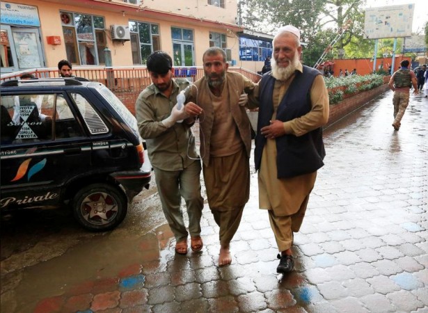 Men carry an injured person to a hospital after a bomb blast at a mosque, in Jalalabad, Afghanistan October 18, 2019. Afghan blast