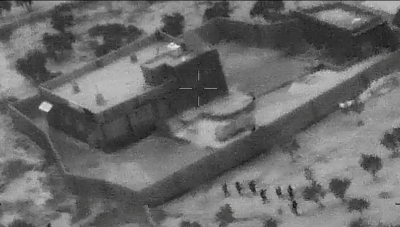 US special forces move towards the compound of Islamic State leader Abu Bakr al-Baghdadi during a raid in the Idlib region of Syria in a still image from video October 26, 2019. Video Baghdadi operation