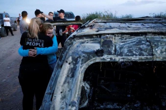 Relatives of slain members of Mexican-American families belonging to Mormon communities react next to the burnt wreckage of a vehicle where some of their relatives died, in Bavispe, Sonora state, Mexico November 5, 2019. Mexican cartel ambush