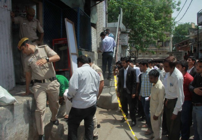 Policemen carry out investigation at Tis Hazari Court where a 40-year-old lawyer was found dead with a head wound inside the court complex on April 17, 2015. Tis Hazari violence