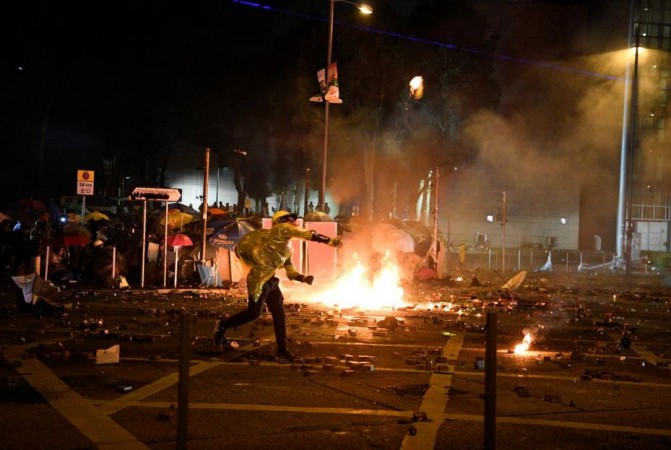 An anti-government protester throws a petrol bomb during a clash with police at Hong Kong Polytechnic University in Hong Kong, China November 18, 2019. Hong Kong university violence