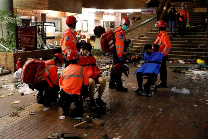 Protesters are taken outside Hong Kong Polytechnic University (PolyU) campus to receive medical aid, in Hong Kong, China November 19, 2019. Hong Kong university violence