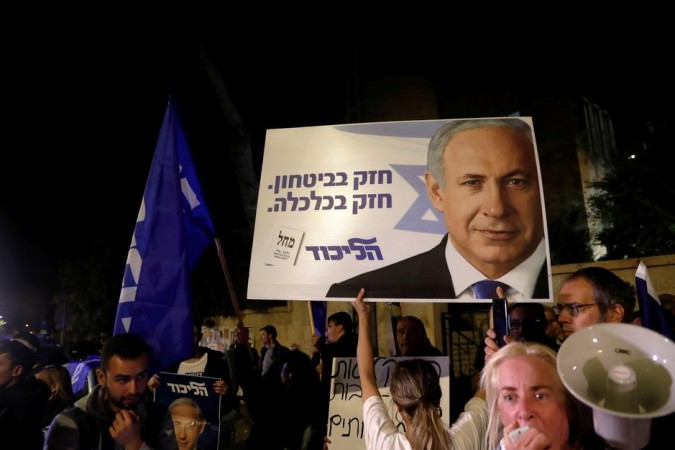 Supporters of Israeli Prime Minister Benjamin Netanyahu protest outside his residence following Israel's Attorney General Avichai Mandelblit's indictment ruling. Netanyahu