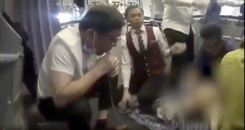 A doctor has been hailed for saving an elderly man's's life by sucking urine from his bladder during mid-flight. urine bladder doctor