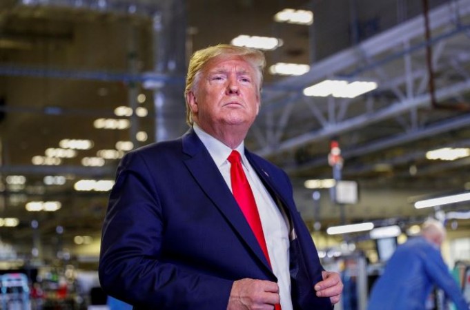 US President Donald Trump adjusts his jacket during a tour of Apple's Mac Pro manufacturing plant in Austin, Texas, US, November 20, 2019. Trump