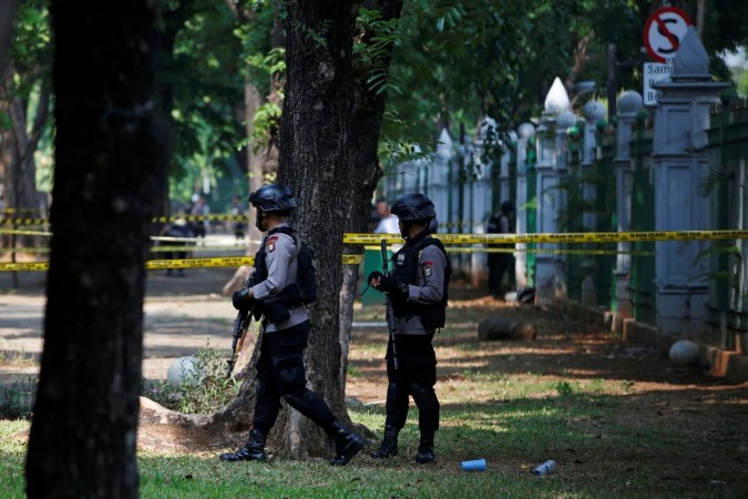 Armed police officers stand guard following a blast at National Monument (Monas) complex in Jakarta. Indonesia blast