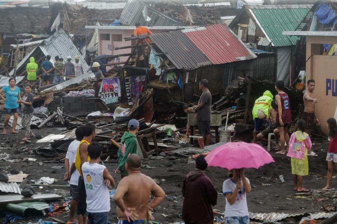 Residents stand among their damaged houses after Typhoon Kammuri hit Legazpi City, Albay, Philippines, December 2, 2019. REUTERS Typhoon Kammuri