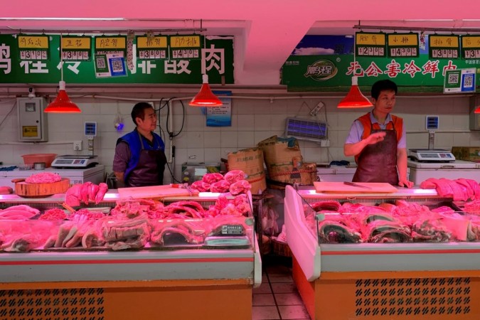 Pork vendors' stalls at a market in Beijing, China. US China
