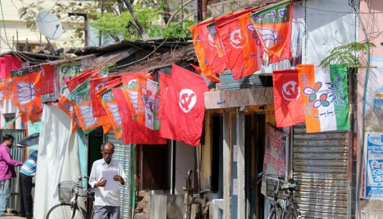 Balurghat: Flags of various political parties are on display at a roadside shop in Balurghat of West Bengal, political parties flags