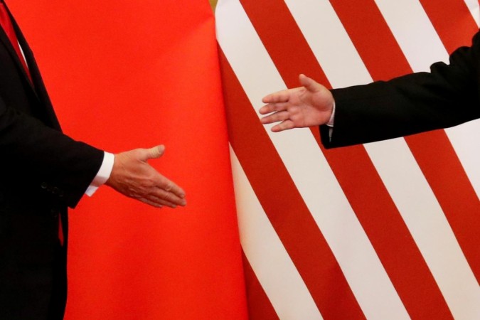 US President Donald Trump and China's President Xi Jinping shake hands. US China