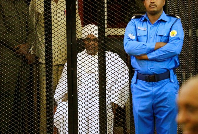 Sudanese former president Omar Hassan al-Bashir sits inside a cage during the hearing of the verdict. Omar al-Bashir