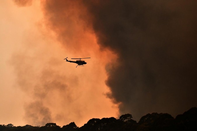 A helicopter is seen during a bushfire near Bilpin, 90 km north-west of Sydney. Australia bush fire