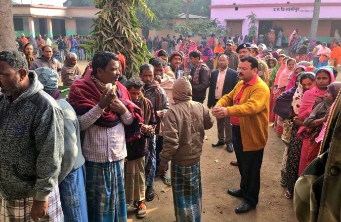 Voters being served with tea as they queue up at a polling station in Jharkhand. Jharkhand elections