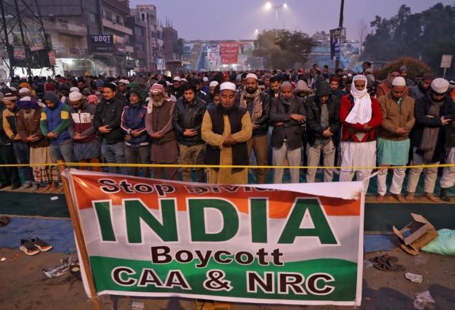Local residents offer prayers on a road during a protest against a new citizenship law, in New Delhi. CAA protests