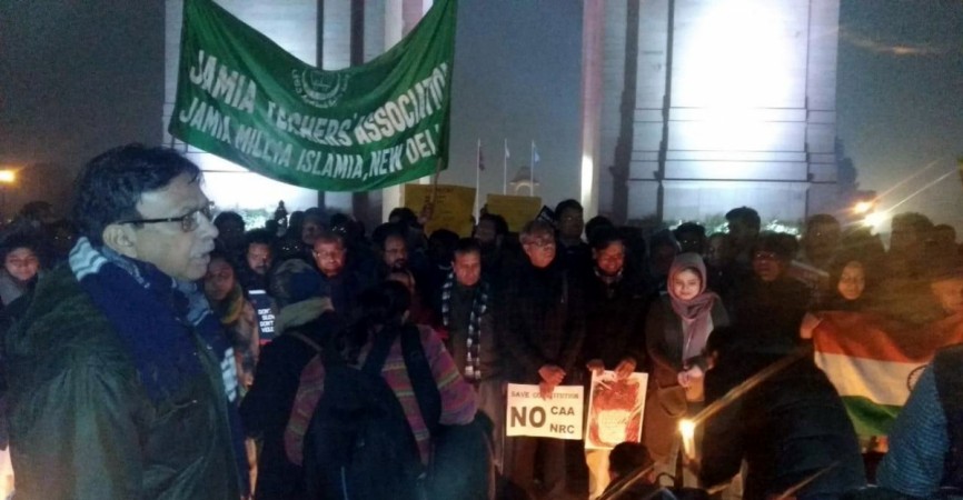 Jamia Millia Islamia teachers under the banner of Jamia Teachers' Association, participate in a candlelight protest march against CAA. Jamia protests