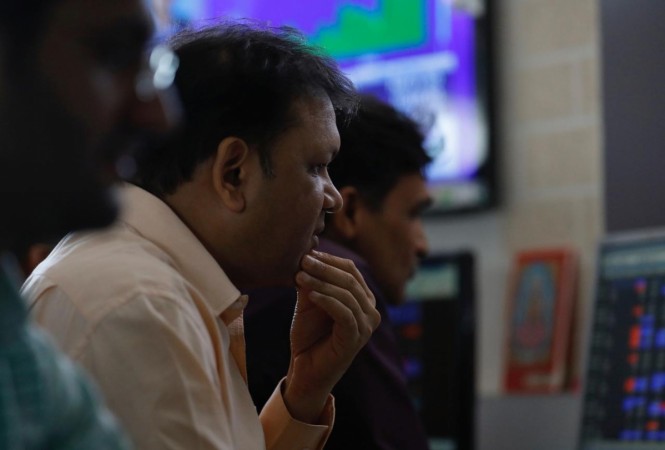 A broker reacts while trading at his computer terminal at a stock brokerage firm in Mumbai. Sensex, Nifty